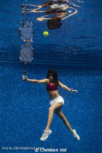 Woman playing tennis underwater, just for fun!! by Christian Vizl 